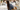 Woman leans over to touch a bed in a lineup at a store
