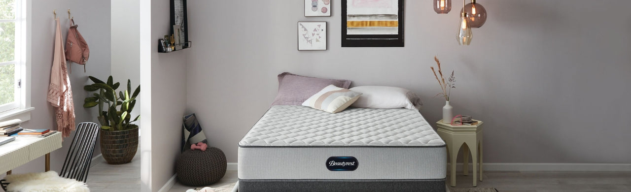 Light gray BR800 mattress in a gray room decorated with pink accessories